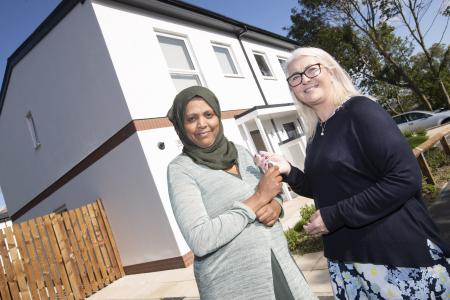 Ms Kahesay receives the keys to her new house