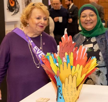 A Little Bit of Good in the World sculpture which shows hands reaching up and out to each other on display in the Memorial Flames exhibition at the Central Hall, Westminster