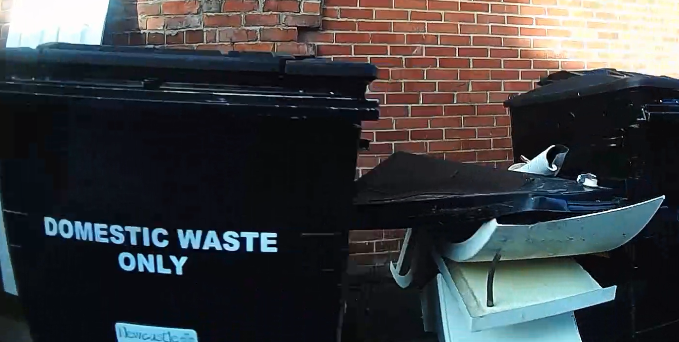 Large pieces of plastic, with metal legs, flytipped between shared black domestic wheelie bins near Wingrove Road and Severus Road in Newcastle