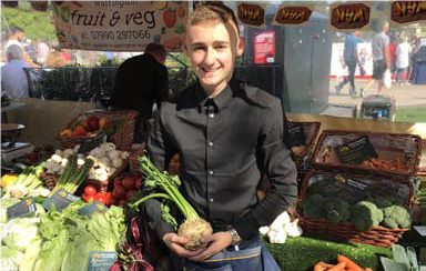 Boy holding onion at market stall